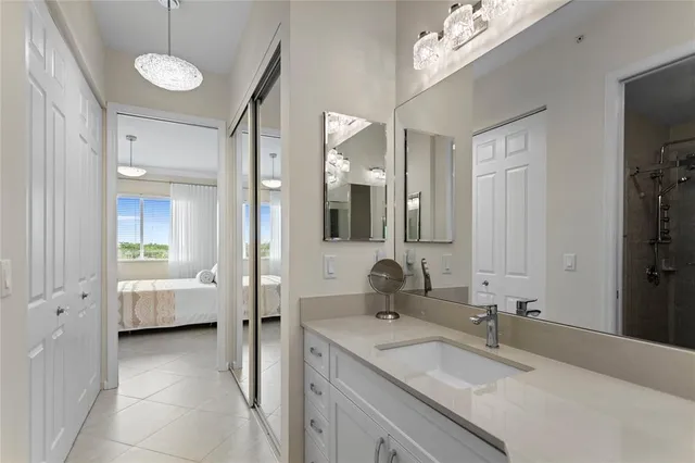 a view of a kitchen with refrigerator and a sink