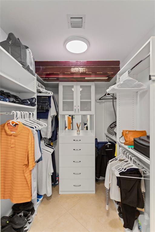 3500 Oaks Clubhouse Drive, Unit 505 Pompano Beach, FL 33069 - Photo 30 of 33 a view of walk in closet with clothes and shoes