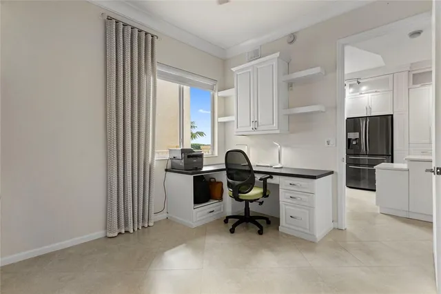 a view of a workspace with furniture and a window