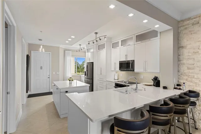 a kitchen with stainless steel appliances granite countertop a sink and cabinets