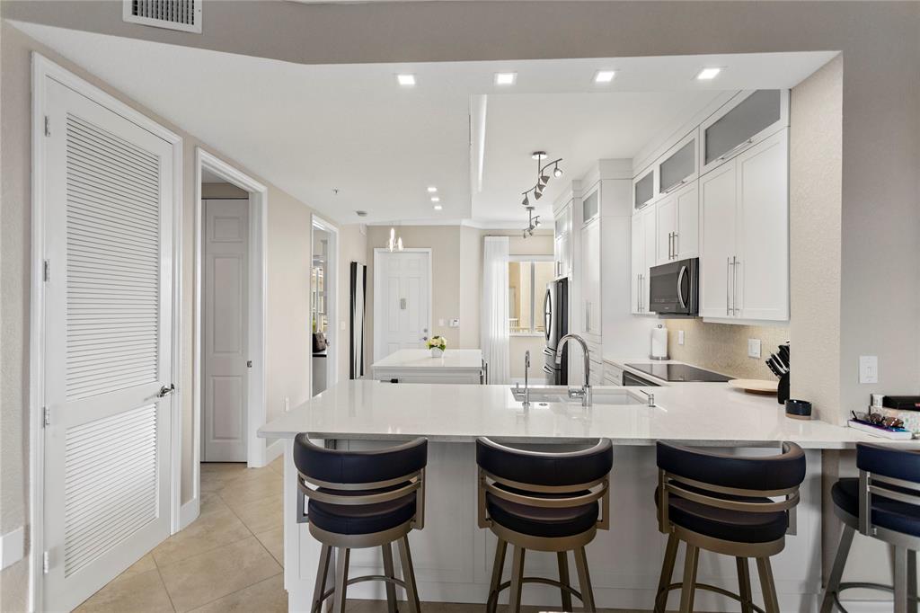 3500 Oaks Clubhouse Drive, Unit 505 Pompano Beach, FL 33069 - Photo 6 of 33 a kitchen with stainless steel appliances granite countertop a sink and cabinets