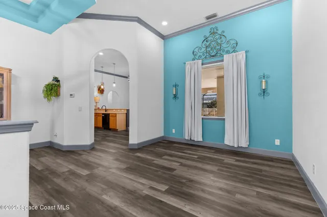 a view of a hallway with entryway dining area and livingroom view