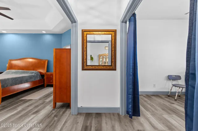 a bedroom with a large bed and a chandelier