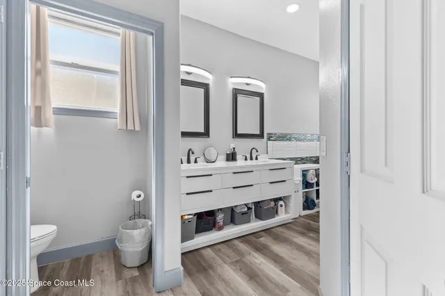 a bathroom with a granite countertop sink mirror and a bathtub