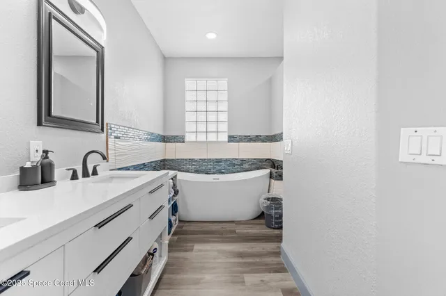 a bathroom with a bathtub and shower