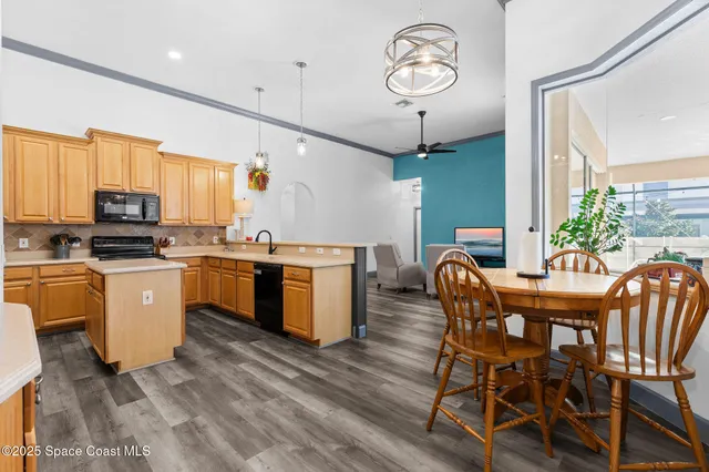 a kitchen with kitchen island granite countertop wooden floors and stainless steel appliances