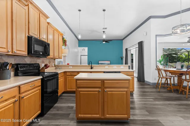 a kitchen with a stove a sink and a refrigerator