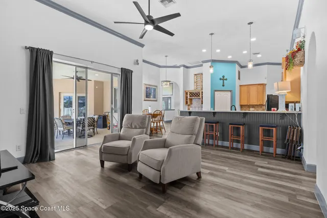 a living room with a baby crib furniture and a window