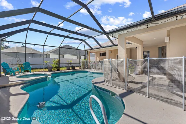 an aerial view of a house with a yard basket ball court and outdoor seating