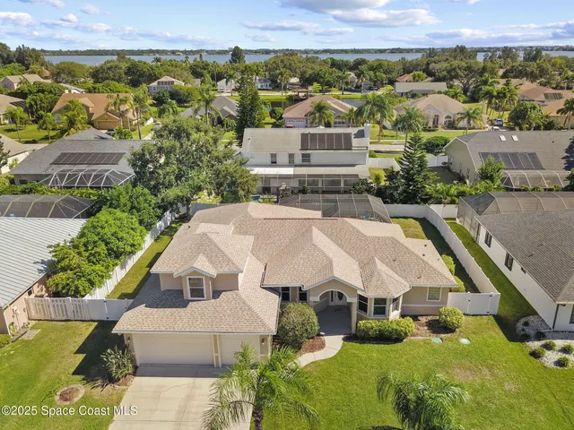 an aerial view of a house with a yard