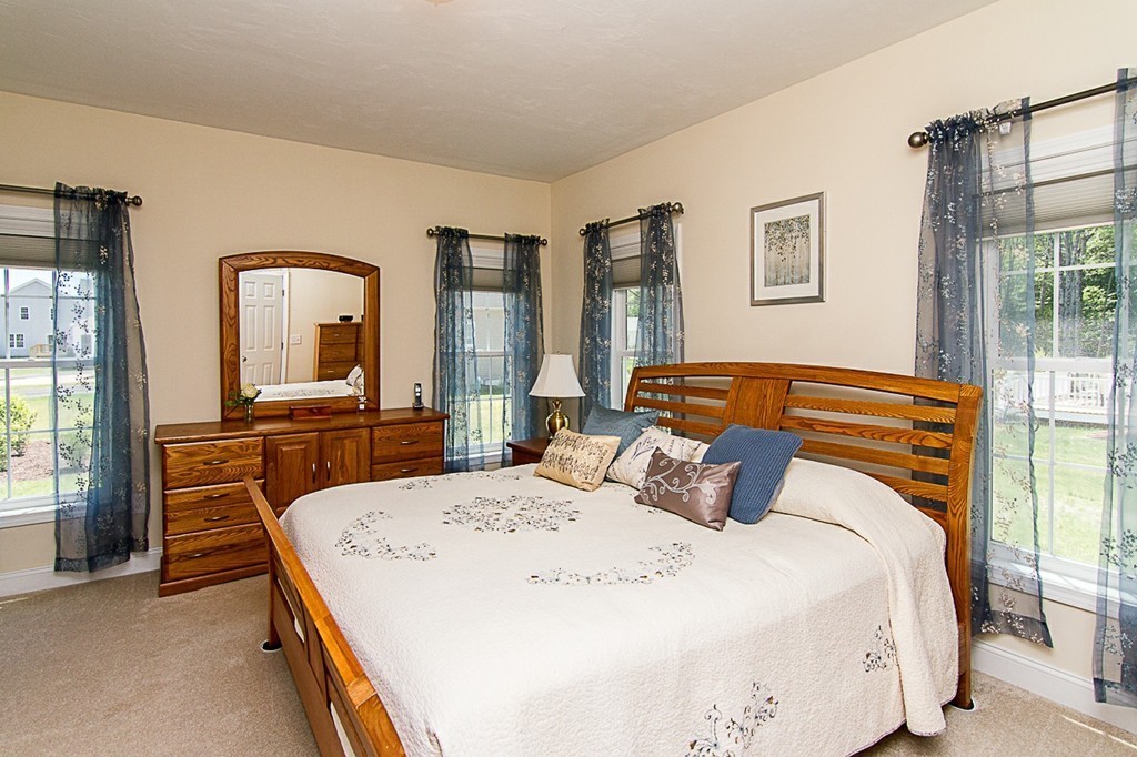19 Geordan Avenue Bellingham, MA 02019 - Photo 15 of 22 a bedroom with a bed and dresser with mirror