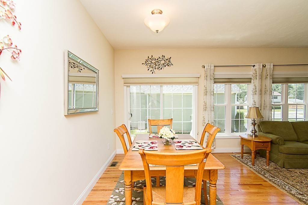 19 Geordan Avenue Bellingham, MA 02019 - Photo 10 of 22 a view of a dining room with furniture wooden floor and a chandelier