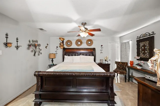 a spacious bathroom with a toilet a sink and a mirror