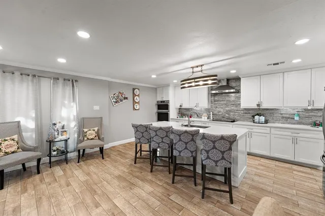 a kitchen with center island table and chairs in it