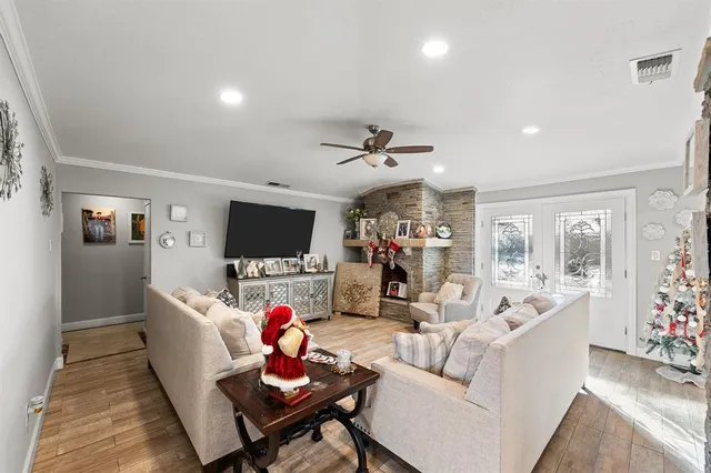 a living room with furniture a flat screen tv and a large window