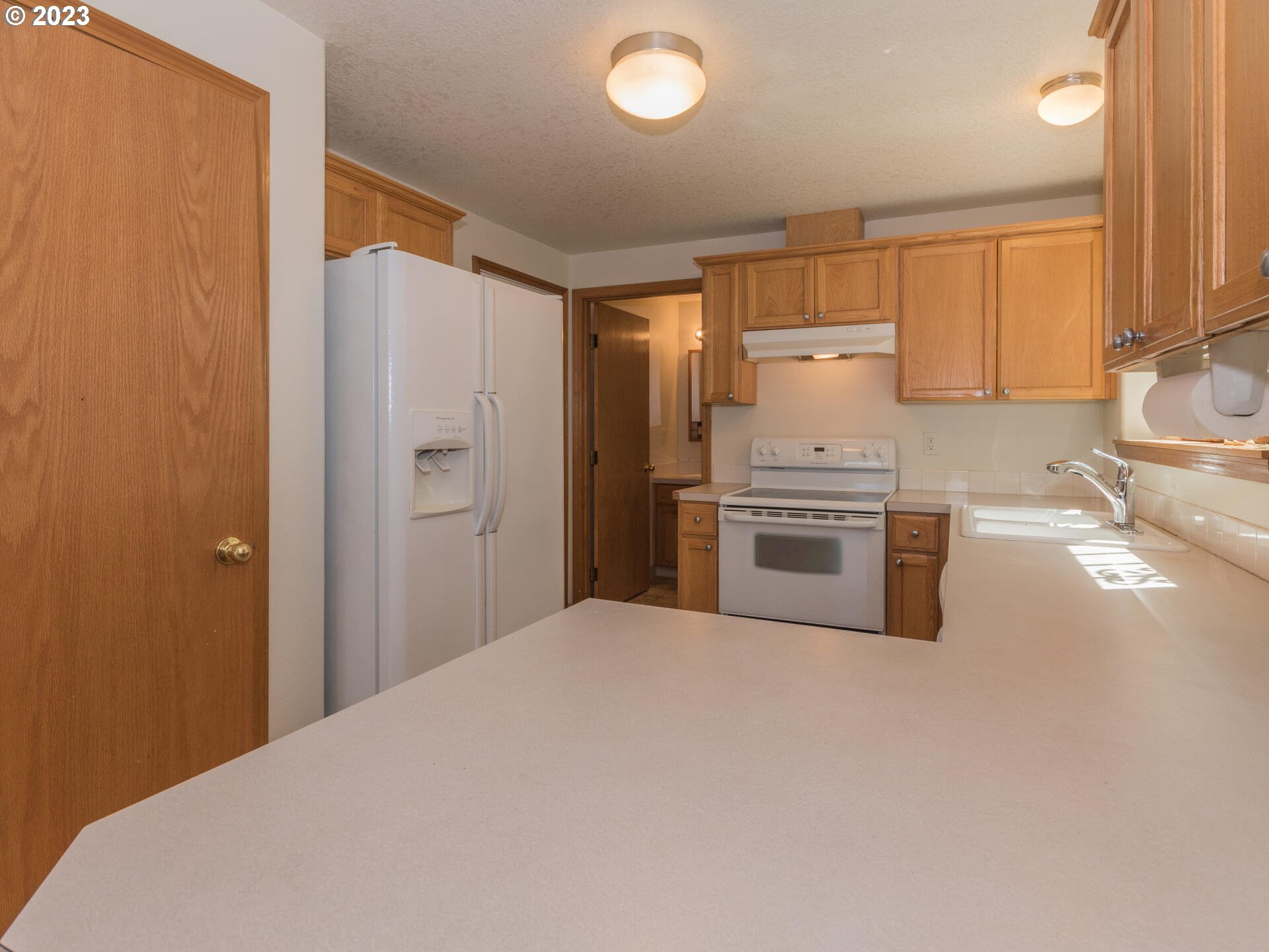 1058 Southwest Ivory Loop Gresham, OR 97080 - Photo 13 of 31 a kitchen with stainless steel appliances a refrigerator and a stove top oven