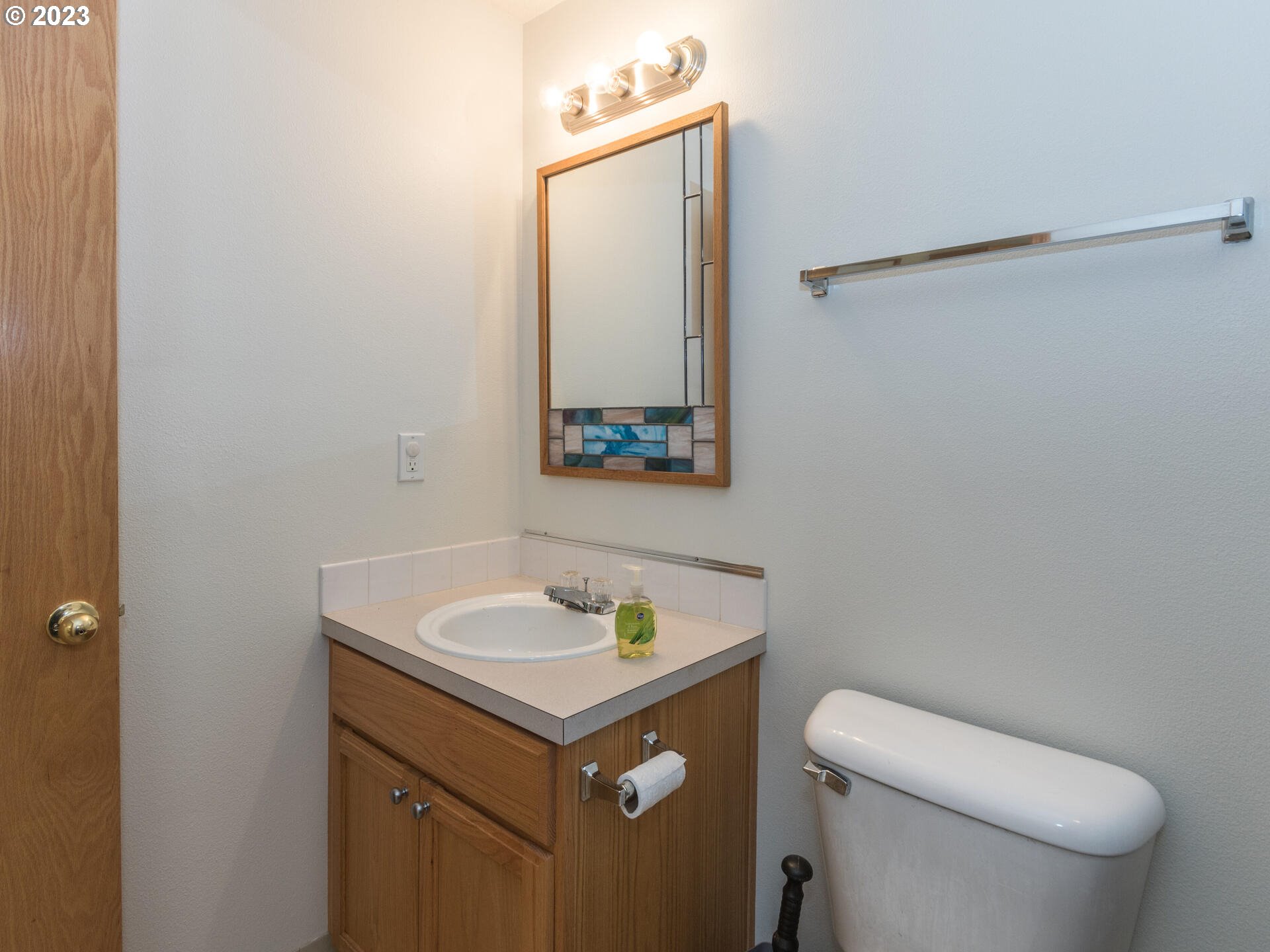 1058 Southwest Ivory Loop Gresham, OR 97080 - Photo 17 of 31 a bathroom with a sink a toilet and mirror