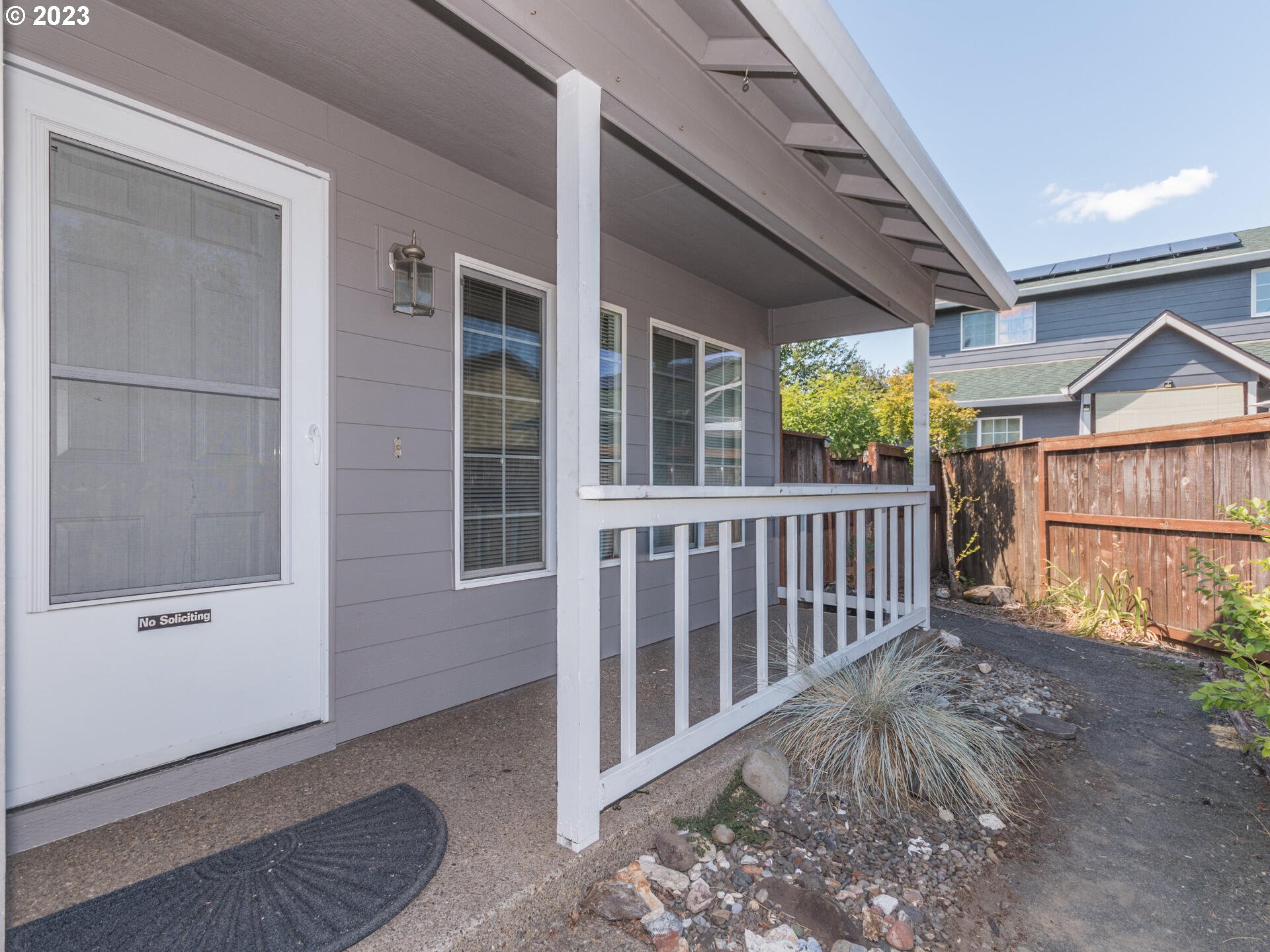 1058 Southwest Ivory Loop Gresham, OR 97080 - Photo 4 of 31 a porch with a bench in front of house