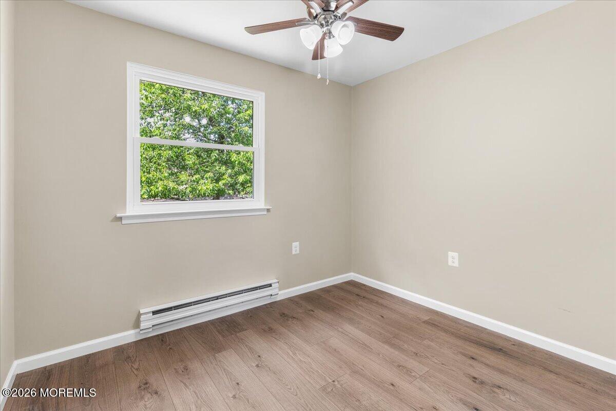 16 D Spring Street, Unit 50 Whiting, NJ 08759 - Photo 23 of 28 an empty room with wooden floor and windows
