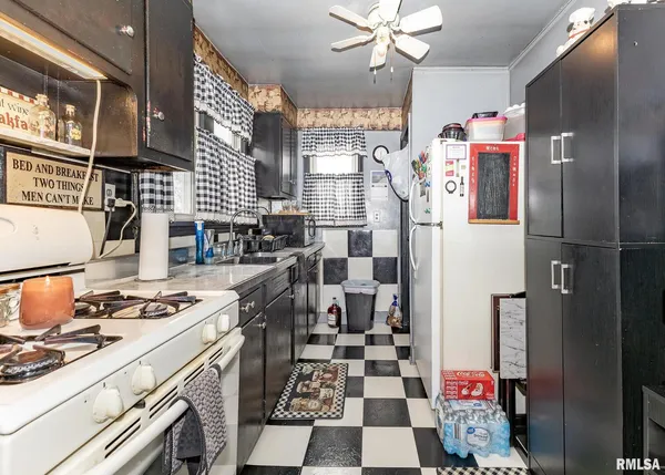 a kitchen with stainless steel appliances a sink a stove a refrigerator and cabinets