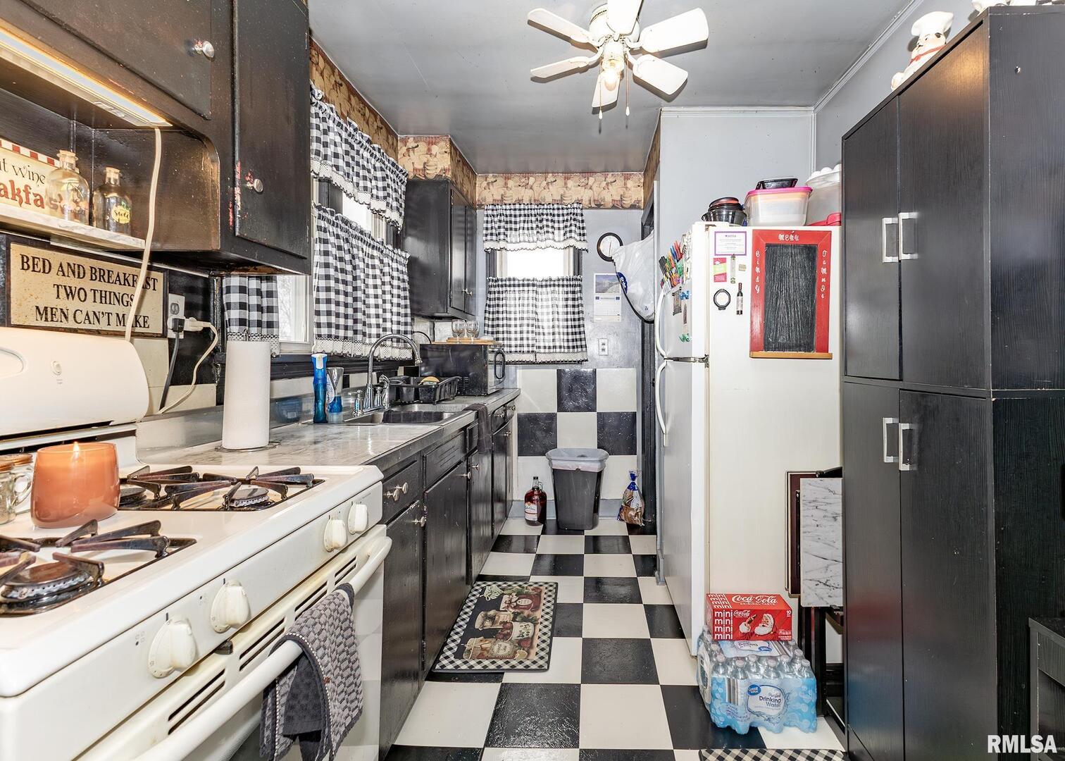 116 West Garfield Street Kewanee, IL 61443 - Photo 14 of 23 a kitchen with stainless steel appliances a sink a stove a refrigerator and cabinets