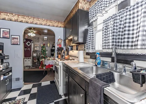 a kitchen with a sink stove and cabinets