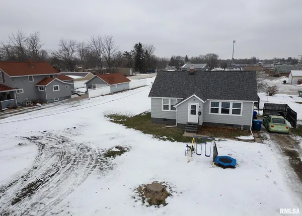 an aerial view of a house with a yard covered in snow