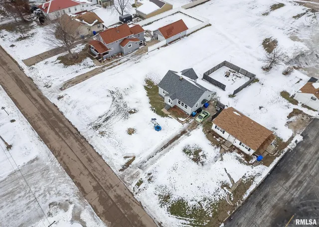 an aerial view of a house with a yard