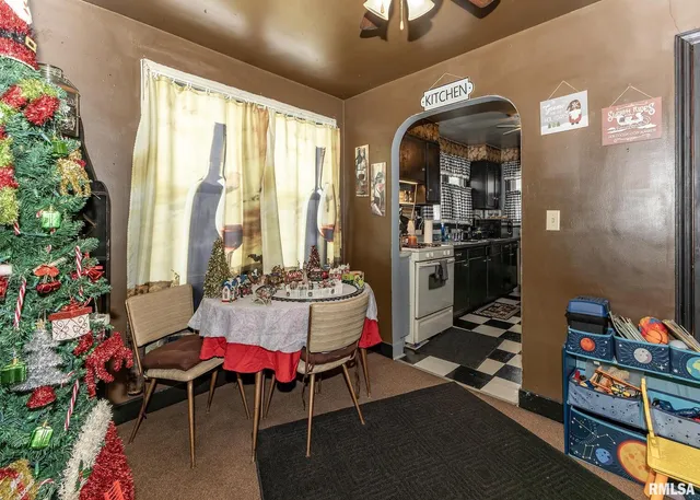 a living room with furniture and a dining table