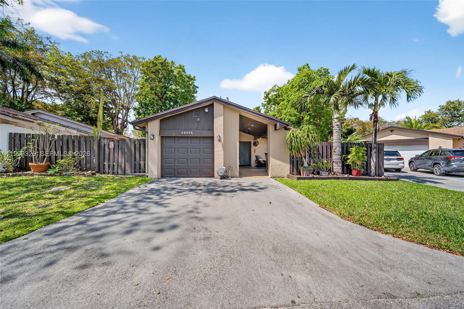 10861 Southwest 132nd Cir Court Miami, FL 33186 - Photo 1 of 42 a front view of a house with a yard and garage