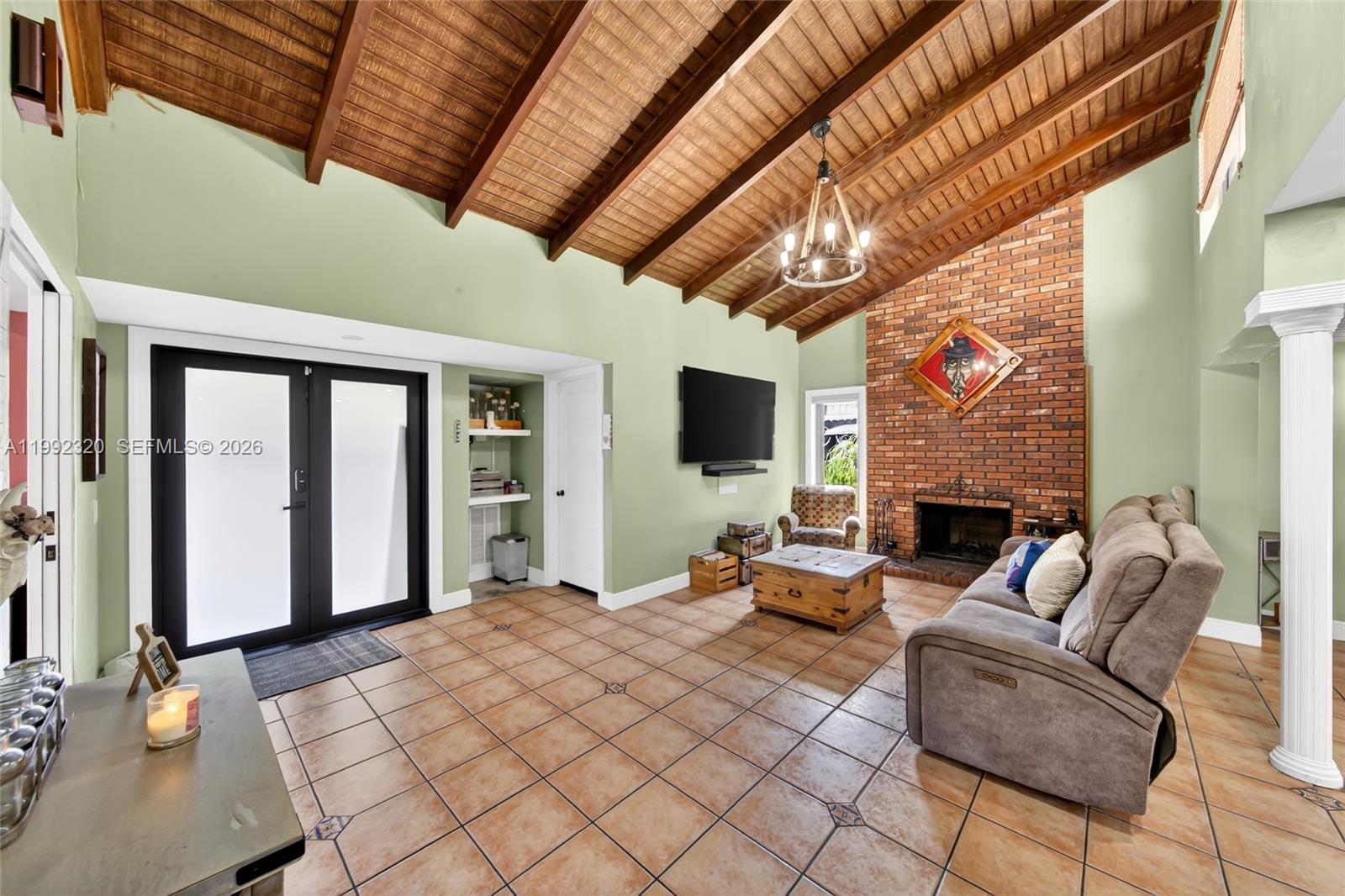 10861 Southwest 132nd Cir Court Miami, FL 33186 - Photo 14 of 42 a living room with furniture a flat screen tv and a fireplace