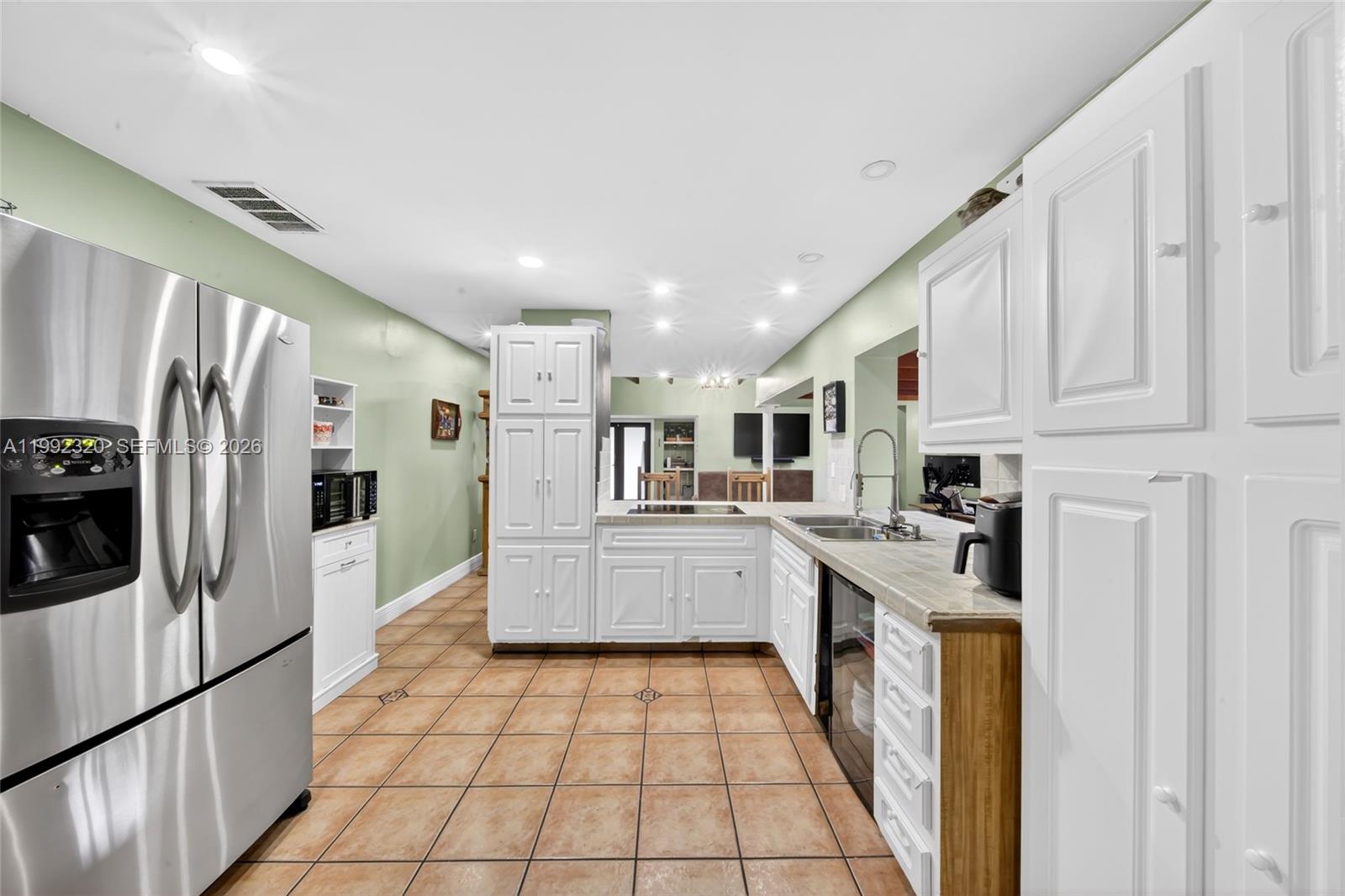 10861 Southwest 132nd Cir Court Miami, FL 33186 - Photo 26 of 42 a kitchen with stainless steel appliances granite countertop a refrigerator and a stove top oven