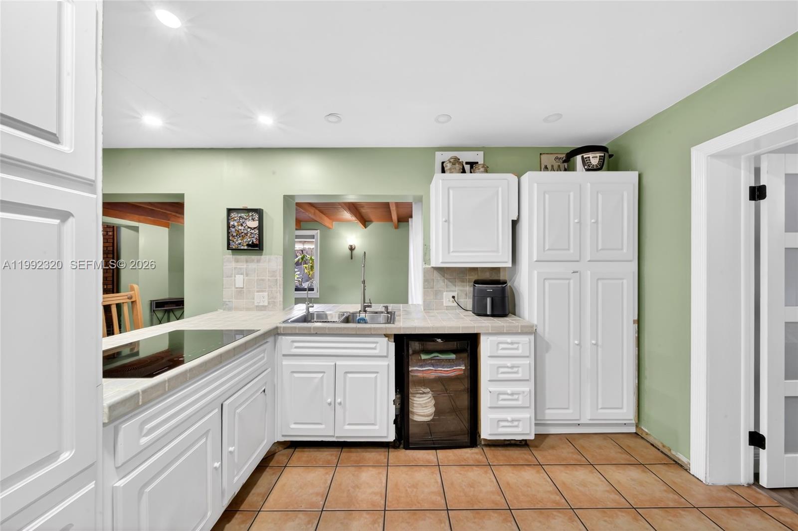 10861 Southwest 132nd Cir Court Miami, FL 33186 - Photo 27 of 42 a kitchen with a sink a refrigerator and cabinets