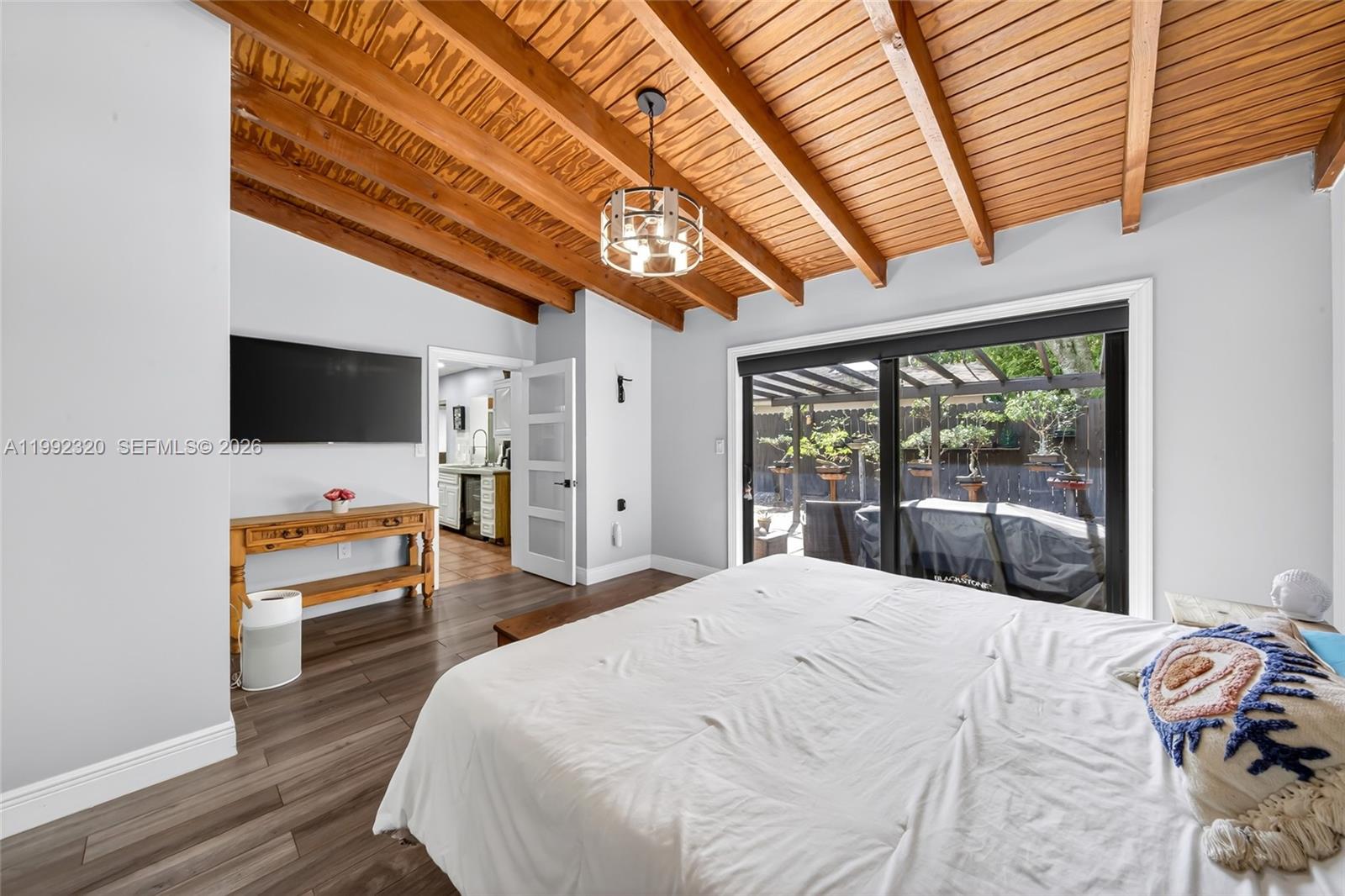 10861 Southwest 132nd Cir Court Miami, FL 33186 - Photo 32 of 42 a bedroom with a bed and a flat screen tv