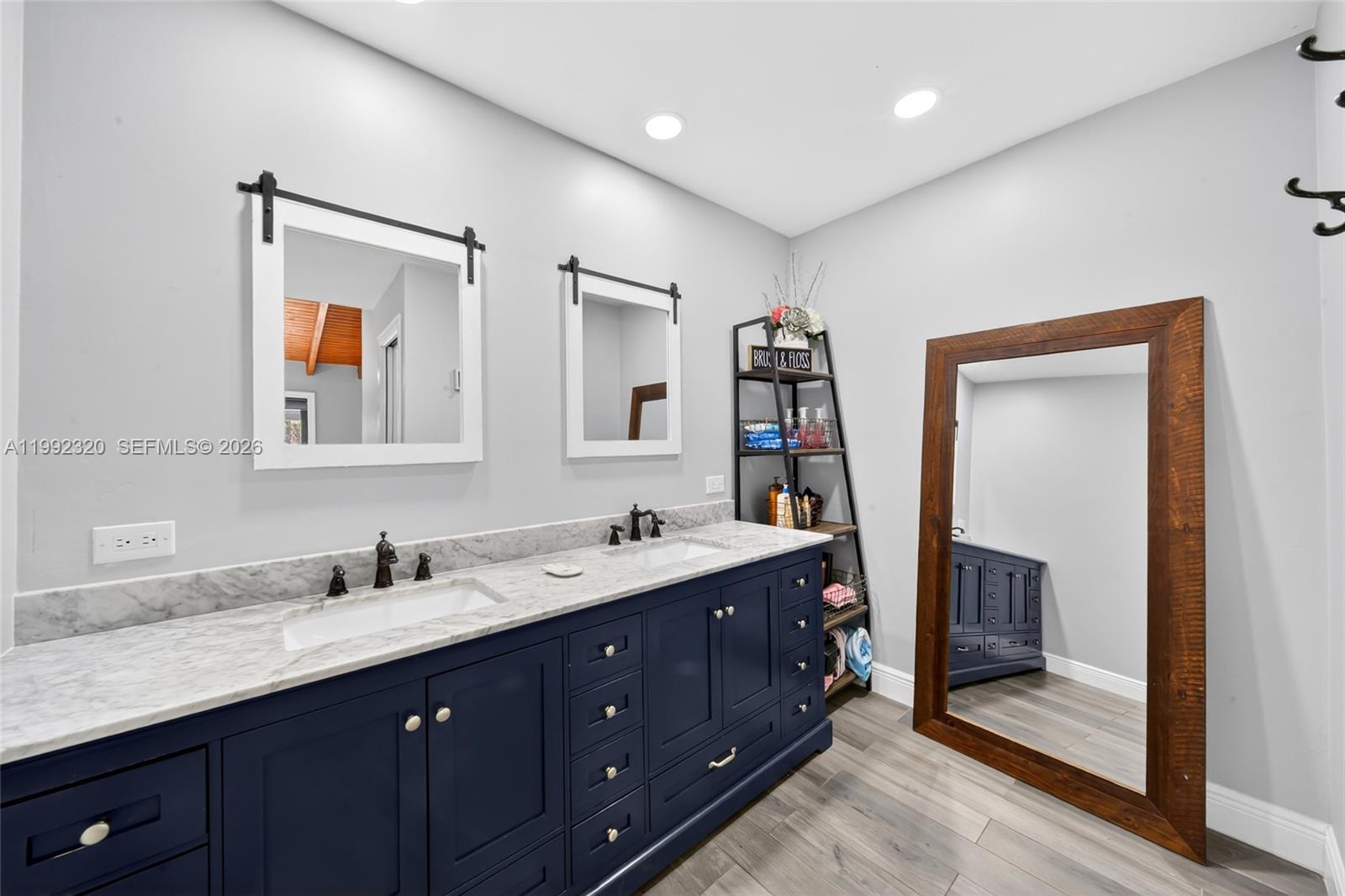 10861 Southwest 132nd Cir Court Miami, FL 33186 - Photo 34 of 42 a bathroom with a double vanity sink and a mirror
