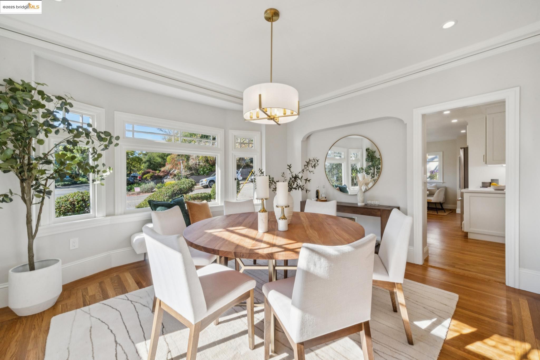 1833 Sonoma Avenue Berkeley, CA 94707 - Photo 16 of 57 a dining room with wooden floor a chandelier a glass table and chairs