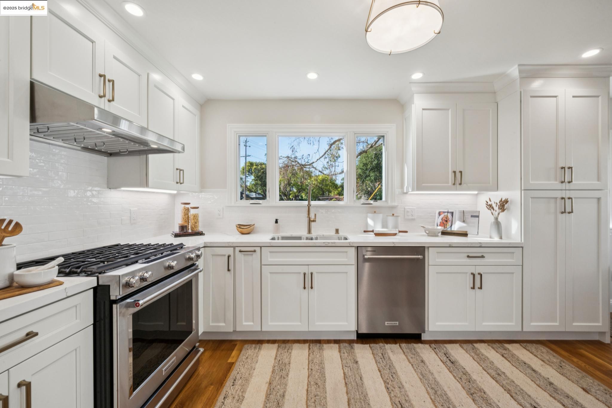 1833 Sonoma Avenue Berkeley, CA 94707 - Photo 18 of 57 a kitchen with stainless steel appliances a stove sink and cabinets