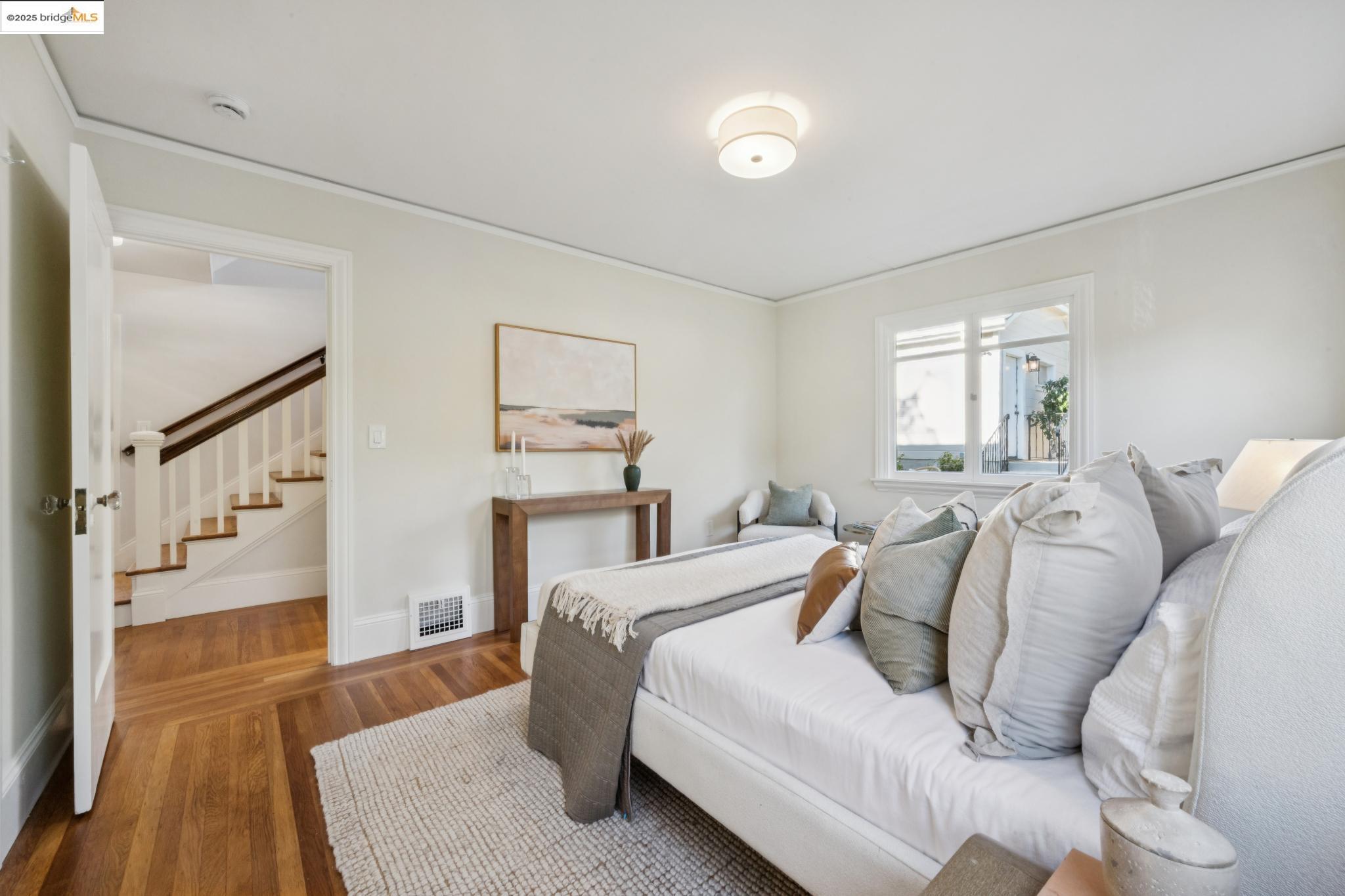 1833 Sonoma Avenue Berkeley, CA 94707 - Photo 24 of 57 a bedroom with a bed and wooden floor