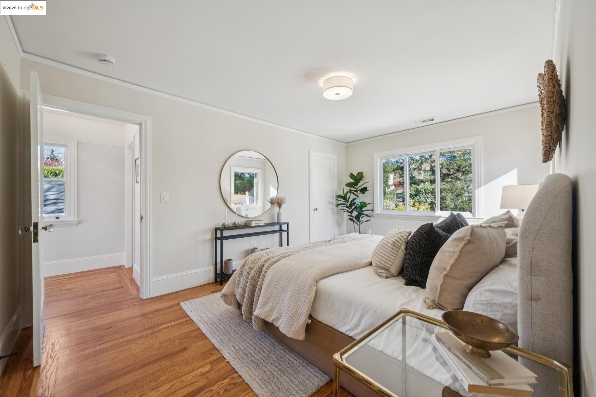 1833 Sonoma Avenue Berkeley, CA 94707 - Photo 32 of 57 a bedroom with a bed a large window with wooden floor and windows