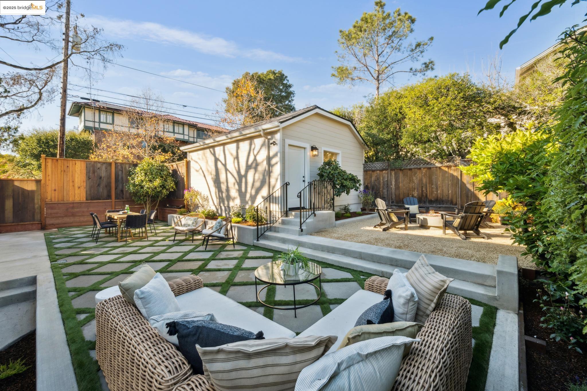 1833 Sonoma Avenue Berkeley, CA 94707 - Photo 41 of 57 Fenced backyard with a patio area, an outdoor living space with a fire pit, an outbuilding, and outdoor dining area