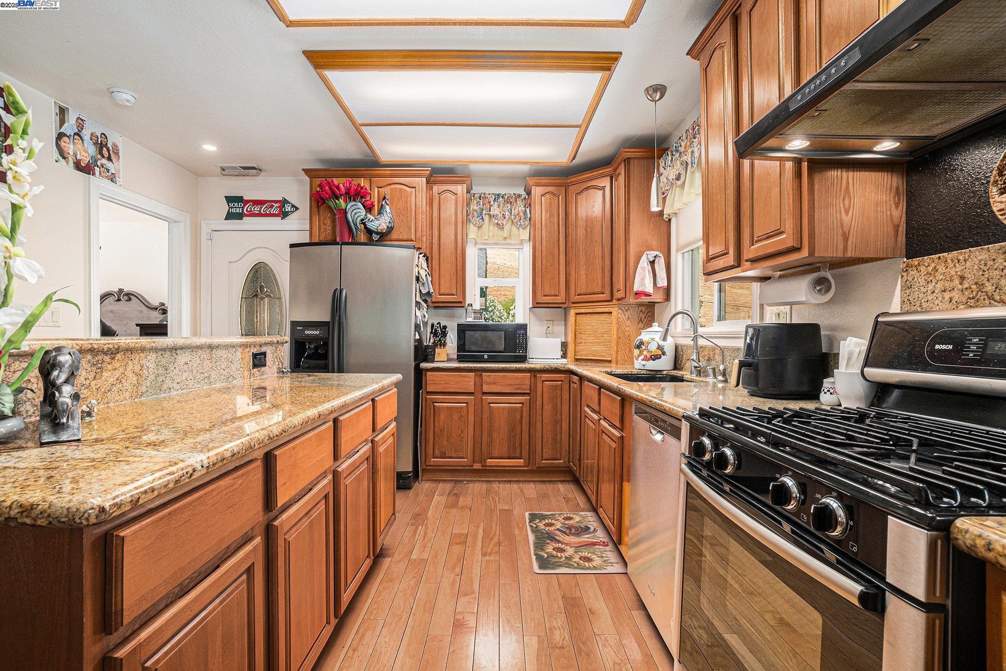 5799 Nortonville Road Pittsburg, CA 94565 - Photo 20 of 59 a kitchen with stainless steel appliances granite countertop a stove and a sink