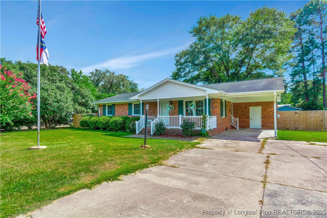 994 East Great Marsh Church Road St. Pauls, NC 28384 - Photo 2 of 30 a front view of a house with a yard and garage