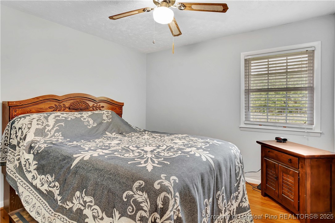 994 East Great Marsh Church Road St. Pauls, NC 28384 - Photo 24 of 30 a bedroom with a bed and a chandelier