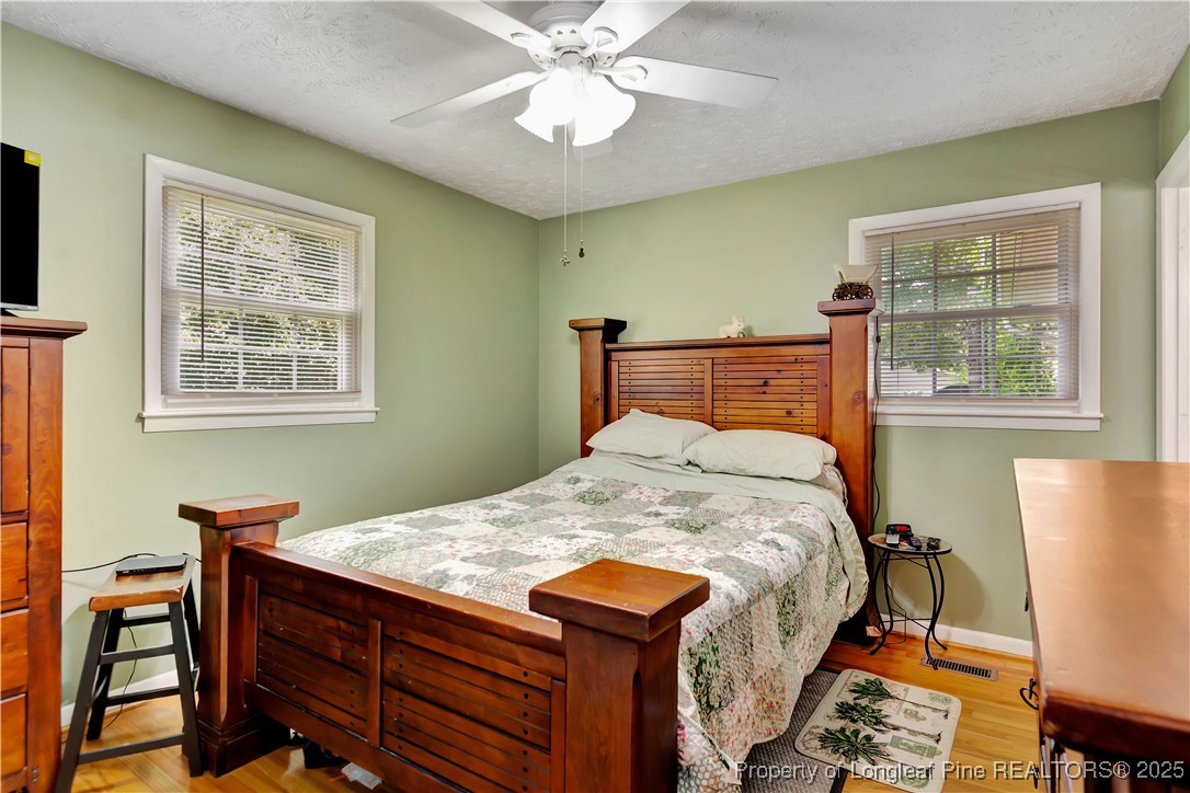 994 East Great Marsh Church Road St. Pauls, NC 28384 - Photo 28 of 30 a bed sitting in a bedroom next to a window
