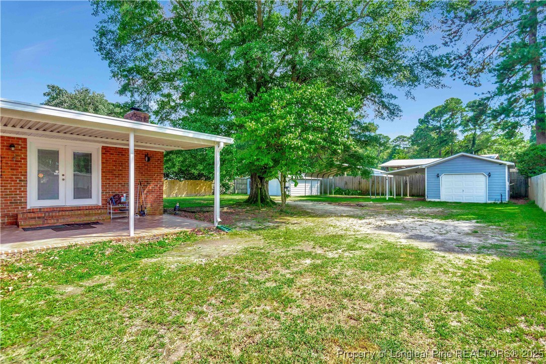 994 East Great Marsh Church Road St. Pauls, NC 28384 - Photo 5 of 30 a view of a house with backyard and a tree
