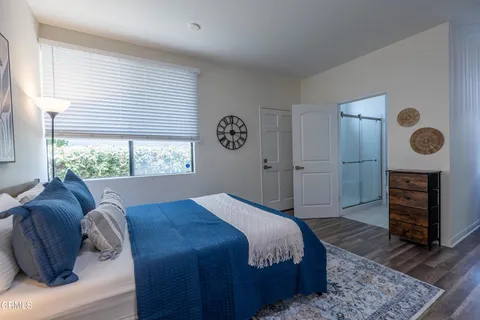 a bedroom with a bed dresser and a window