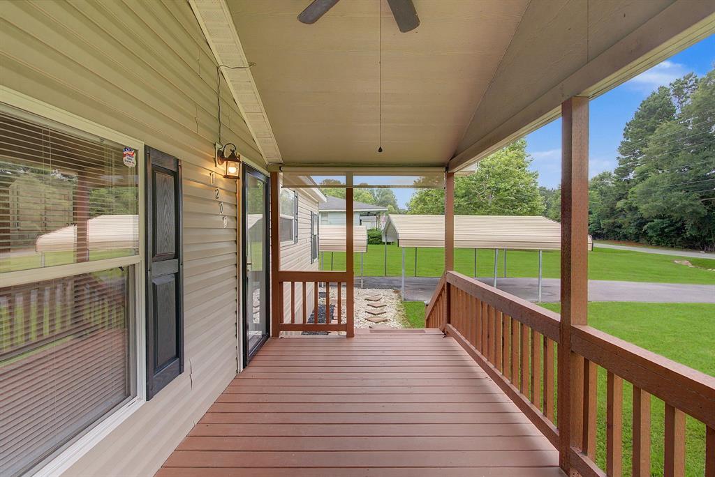 1202 Princeton Road Princeton, LA 71067 - Photo 4 of 19 Spacious covered porch featuring wood-finish decking, matching railings, and a ceiling fan