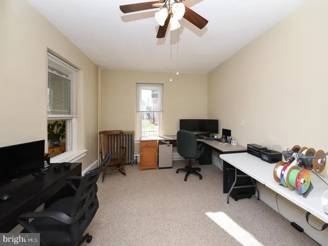 a bedroom with a bed and a view of kitchen