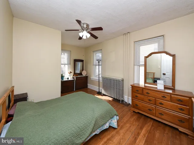 a living room with furniture a window and a flat screen tv