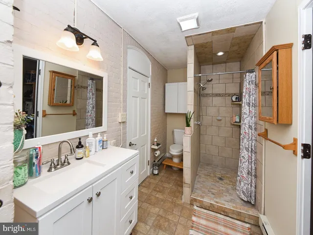 a bathroom with a toilet sink and mirror